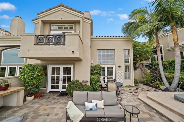 1616 Cormorant Dr, Carlsbad, CA 92011 - back of house featuring french doors, a balcony, stucco siding, a patio area, and an outdoor hangout area