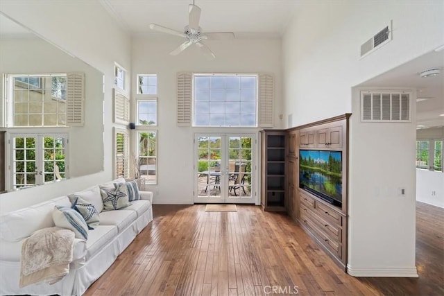 1616 Cormorant Dr, Carlsbad, CA 92011 - living room featuring french doors, a towering ceiling, hardwood / wood-style flooring, baseboards, and ornamental molding