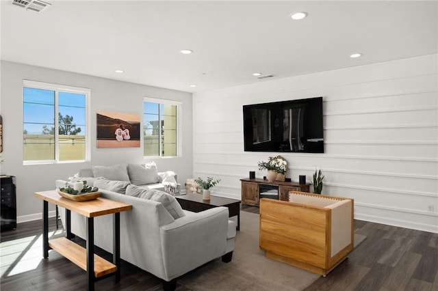 living room featuring recessed lighting, dark wood-type flooring, and baseboards