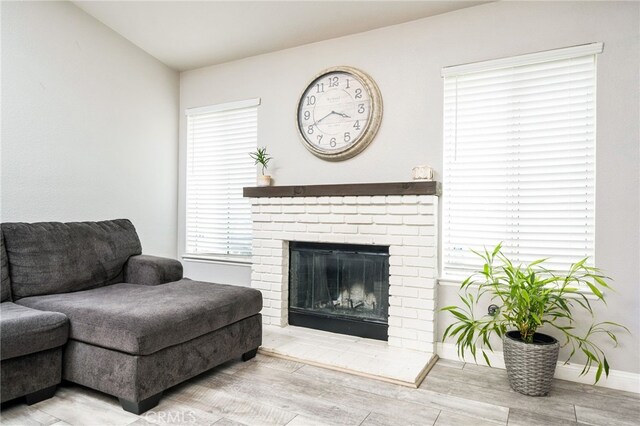 6932 Sundown Dr, Jurupa Valley, CA 92509 - living area with baseboards, wood finished floors, and a fireplace