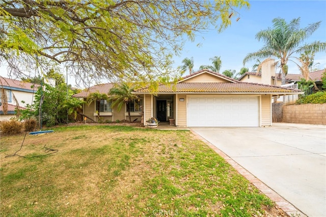 6932 Sundown Dr, Jurupa Valley, CA 92509 - single story home with fence, a tile roof, driveway, and an attached garage