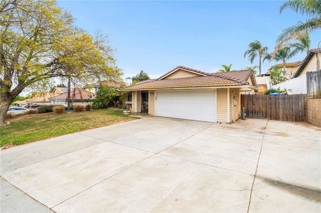 6932 Sundown Dr, Jurupa Valley, CA 92509 - ranch-style house with a front yard, a garage, driveway, a tiled roof, and fence