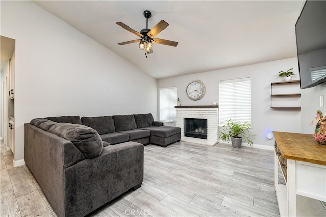 6932 Sundown Dr, Jurupa Valley, CA 92509 - living room featuring light wood finished floors, a fireplace, a ceiling fan, baseboards, and lofted ceiling