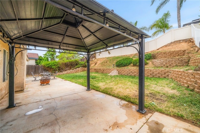 6932 Sundown Dr, Jurupa Valley, CA 92509 - view of patio / terrace featuring a fire pit, a gazebo, and a fenced backyard