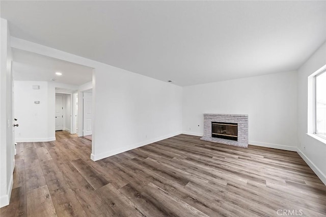 701 Black Oak Cir, Corona, CA 92881 - unfurnished living room with baseboards, a brick fireplace, recessed lighting, and wood finished floors