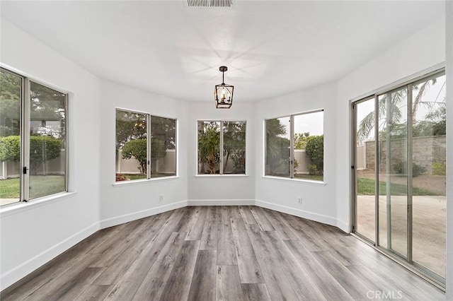 701 Black Oak Cir, Corona, CA 92881 - unfurnished sunroom featuring baseboards, wood finished floors, and a notable chandelier