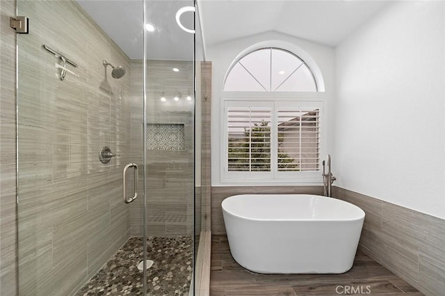 701 Black Oak Cir, Corona, CA 92881 - full bathroom featuring lofted ceiling, a freestanding bath, tile walls, and a shower stall