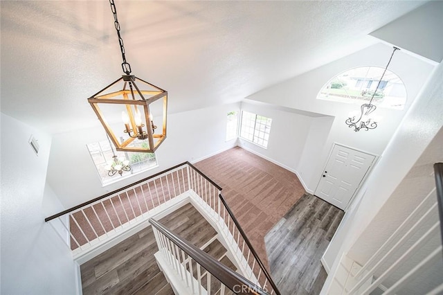 701 Black Oak Cir, Corona, CA 92881 - staircase with wood finished floors, a notable chandelier, and vaulted ceiling