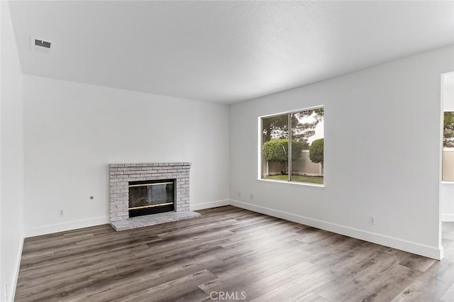 701 Black Oak Cir, Corona, CA 92881 - unfurnished living room featuring baseboards, a fireplace, wood finished floors, and visible vents