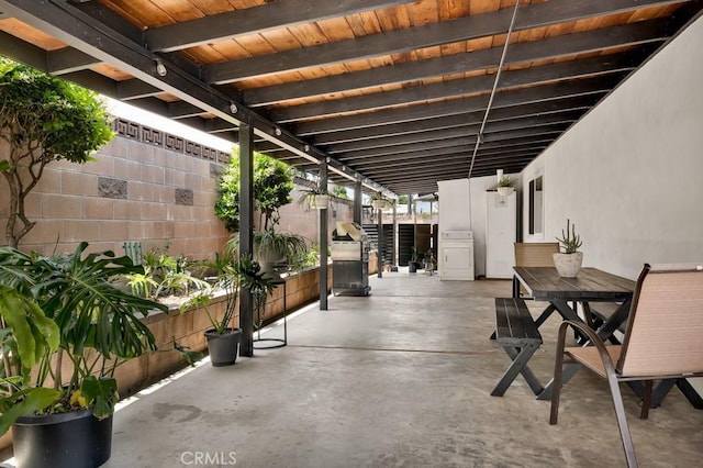 view of patio / terrace with outdoor dining space, washer / clothes dryer, and a fenced backyard
