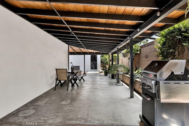 view of patio with outdoor dining space, area for grilling, and fence