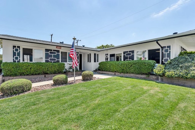 ranch-style house with a front lawn