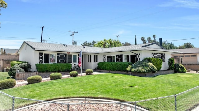 ranch-style house featuring stucco siding, roof with shingles, fence, and a front yard