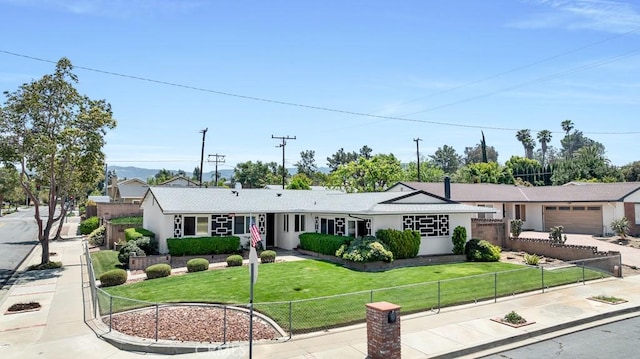 single story home featuring an attached garage, stucco siding, fence private yard, and a front yard