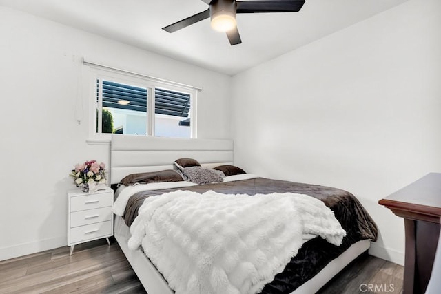 bedroom with baseboards, ceiling fan, and wood finished floors