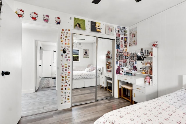 bedroom featuring ceiling fan, a closet, and wood finished floors