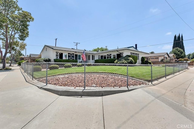 ranch-style house with fence private yard and a front yard