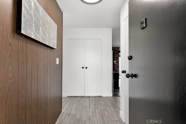 hallway with baseboards and wood finish floors
