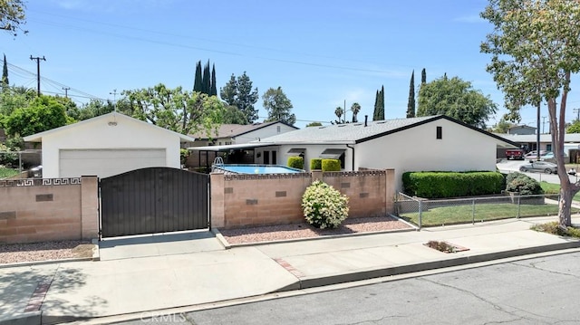 single story home with a fenced front yard, stucco siding, a gate, and driveway
