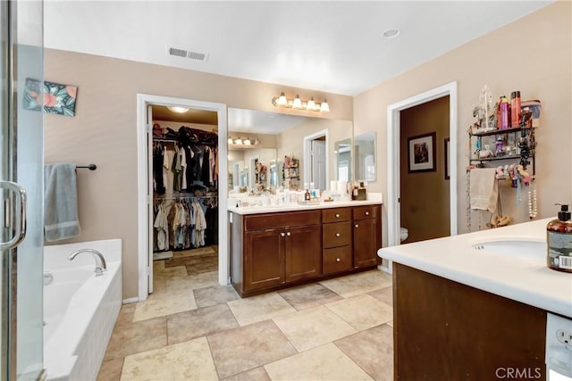 34440 Fawn Ridge Pl, Yucaipa, CA 92399 - bathroom featuring vanity, a garden tub, toilet, and a spacious closet