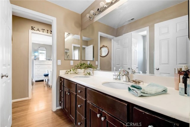 34440 Fawn Ridge Pl, Yucaipa, CA 92399 - bathroom featuring wood finished floors, double vanity, and baseboards