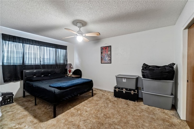 carpeted bedroom featuring a textured ceiling and ceiling fan
