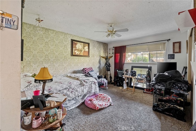 bedroom featuring a ceiling fan, a textured ceiling, and carpet