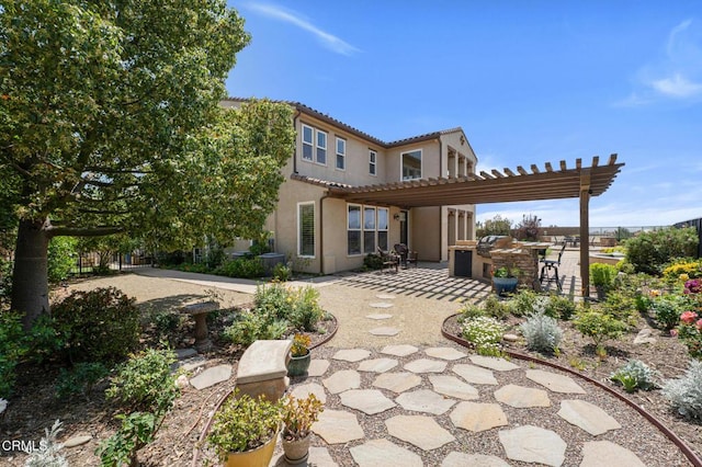 20752 Veneto Way, Porter Ranch, CA 91326 - rear view of house with exterior kitchen, a patio area, a pergola, stucco siding, and a tiled roof