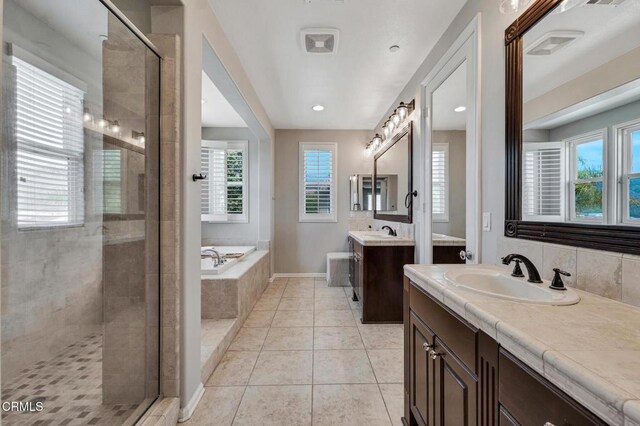 20752 Veneto Way, Porter Ranch, CA 91326 - bathroom with a stall shower, two vanities, a garden tub, and tile patterned flooring