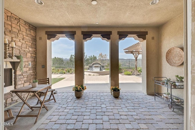 20752 Veneto Way, Porter Ranch, CA 91326 - view of patio / terrace with an outdoor stone fireplace