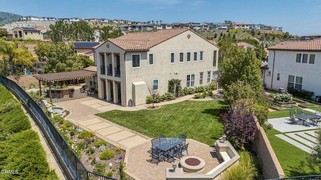 20752 Veneto Way, Porter Ranch, CA 91326 - back of house featuring a patio area, outdoor dining space, stucco siding, an outdoor fire pit, and a residential view