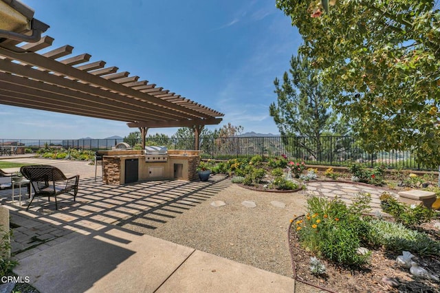 20752 Veneto Way, Porter Ranch, CA 91326 - view of patio with an outdoor kitchen and a pergola