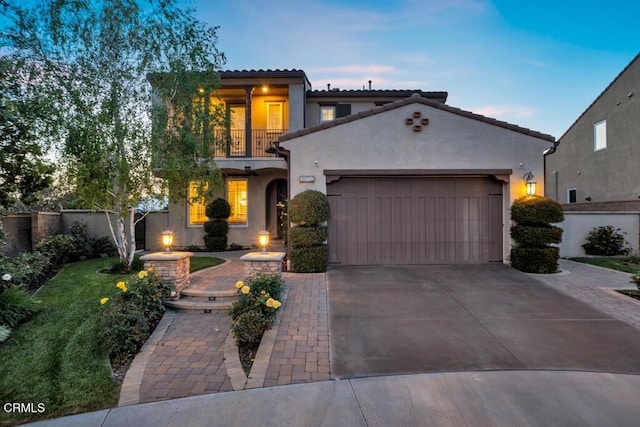 20752 Veneto Way, Porter Ranch, CA 91326 - mediterranean / spanish house featuring a balcony, an attached garage, stucco siding, concrete driveway, and a tile roof