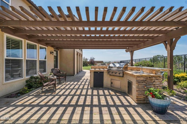 20752 Veneto Way, Porter Ranch, CA 91326 - view of patio featuring an outdoor kitchen and a pergola