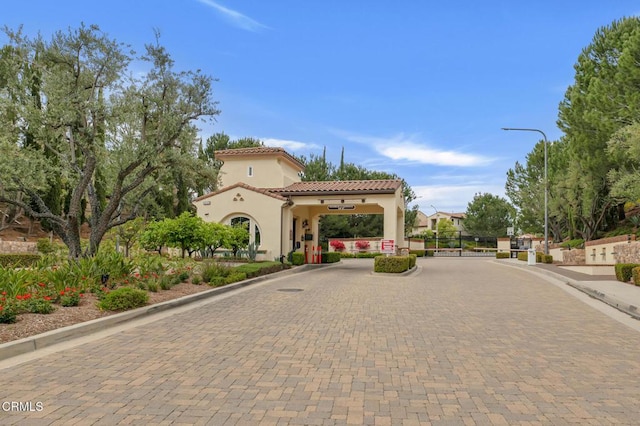 20752 Veneto Way, Porter Ranch, CA 91326 - view of road featuring curbs, street lighting, and a gated entry