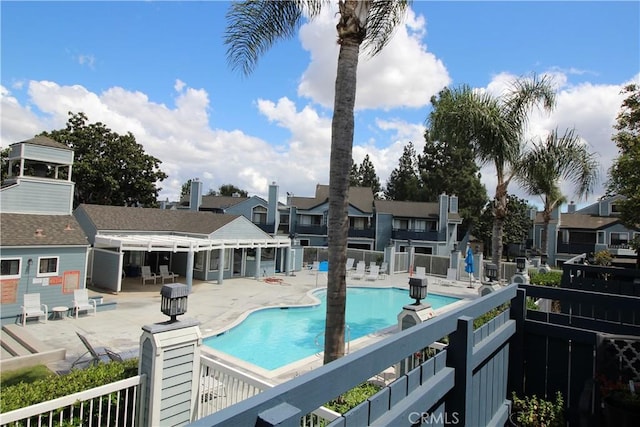 7312 Quill Dr Unit 13, Downey, CA 90242 - community pool featuring a patio area, fence, and a residential view
