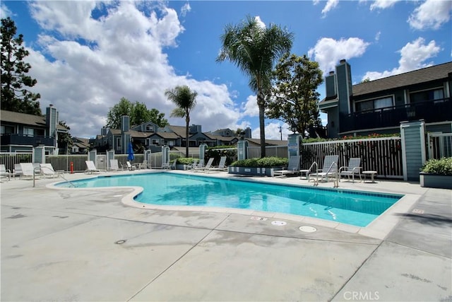 7312 Quill Dr Unit 13, Downey, CA 90242 - community pool with fence, a patio, and a residential view