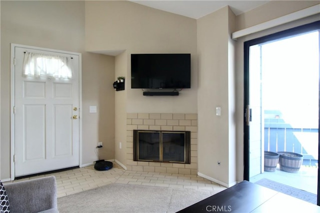 7312 Quill Dr Unit 13, Downey, CA 90242 - unfurnished living room featuring a brick fireplace, baseboards, and tile patterned floors