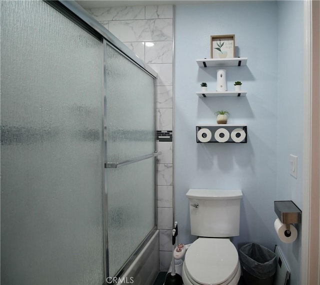 7312 Quill Dr Unit 13, Downey, CA 90242 - bathroom featuring toilet and bath / shower combo with glass door