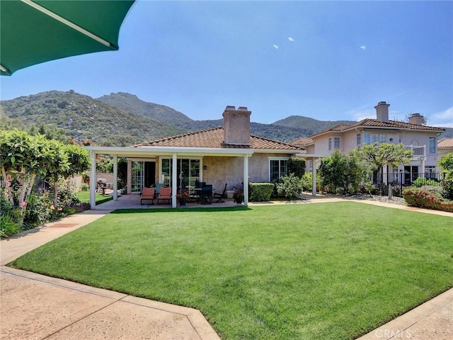 3025 Camino De Las Piedras, El Cajon, CA 92019 - rear view of property with a chimney, a mountain view, stucco siding, a patio, and a tile roof