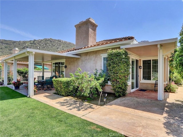 3025 Camino De Las Piedras, El Cajon, CA 92019 - back of house with a chimney, a patio area, a mountain view, stucco siding, and a tile roof
