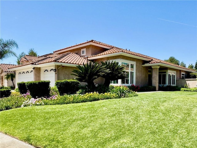 3025 Camino De Las Piedras, El Cajon, CA 92019 - mediterranean / spanish home featuring an attached garage, stucco siding, a front lawn, and a tile roof