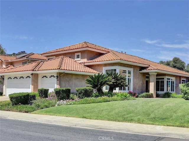 3025 Camino De Las Piedras, El Cajon, CA 92019 - mediterranean / spanish-style house featuring an attached garage, stucco siding, a front lawn, and a tiled roof