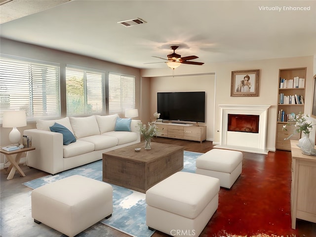living room with built in features, ceiling fan, and visible vents