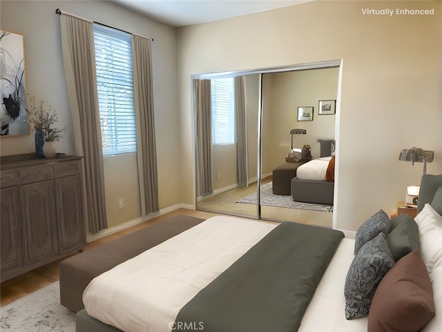 bedroom with a closet, baseboards, and multiple windows