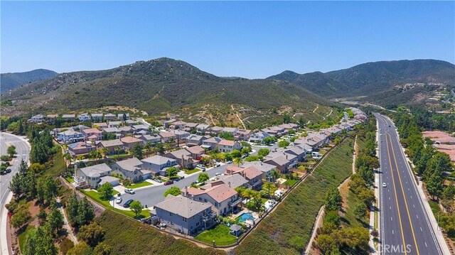 22939 Montanya Pl, Murrieta, CA 92562 - aerial view of property's location featuring nearby suburban area, a mountain backdrop, and a main thoroughfare