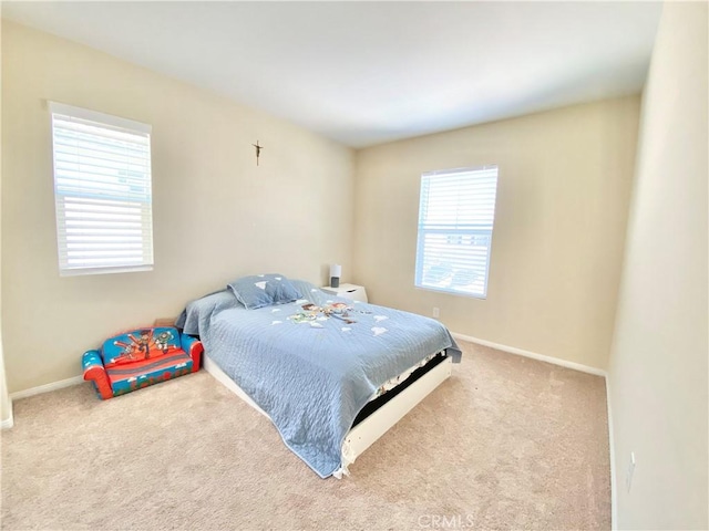 bedroom featuring carpet flooring and baseboards