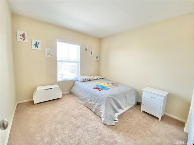 bedroom with carpet and baseboards