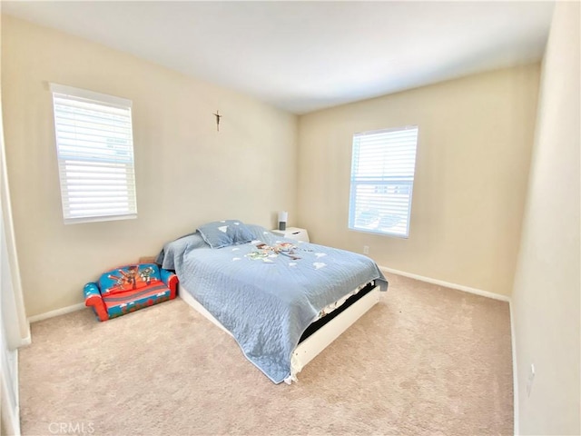 bedroom with baseboards, multiple windows, and carpet flooring