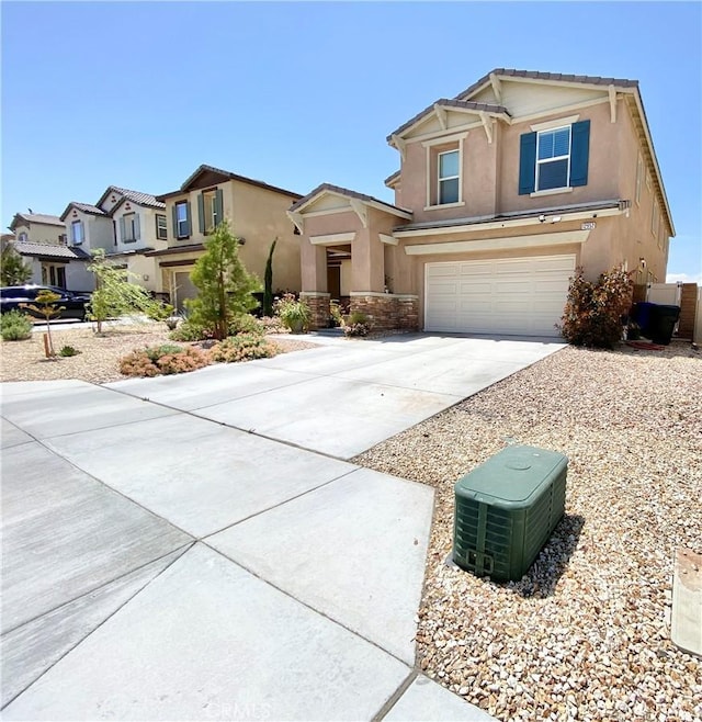 view of front of house featuring a residential view, driveway, an attached garage, and stucco siding